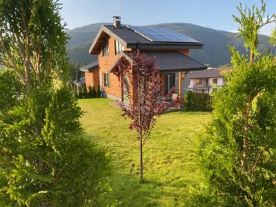 a house with solar panels on top of a yard at HillVill in Govedartsi