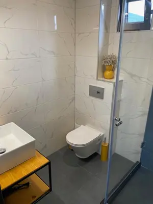 a bathroom with a toilet and a sink and a shower at HillVill in Govedartsi