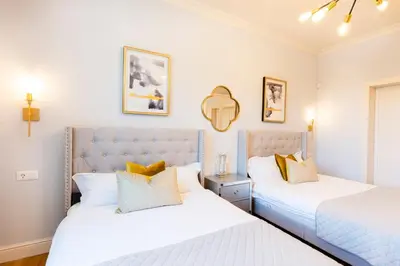 two beds sitting next to each other in a bedroom at Sofia Royal Retreat in Sofia