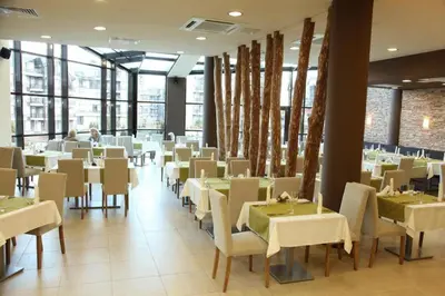 a dining room with white tables and chairs at Фамилно студио Alex&Marry Аспен Резорт Банско in Bansko