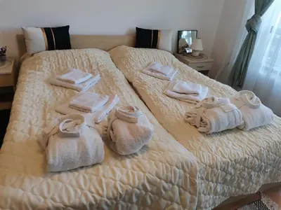 a bedroom with a bed with towels on it at Фамилно студио Alex&Marry Аспен Резорт Банско in Bansko