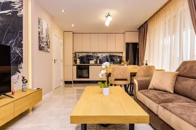 a living room with a couch and a table at Duos of Delight Matching Urban Apartments for Your Plovdiv Adventure by Flat Mаnager in Plovdiv