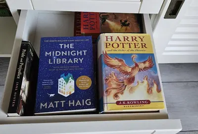 three books sitting on top of a shelf at Four Seasons Apartment Bansko in Bansko