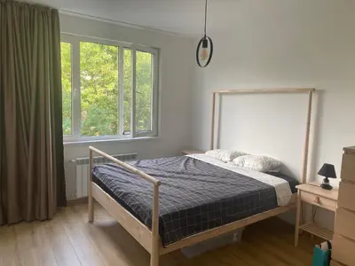 a bedroom with a bed and two windows at Trendy and stylish in city centre for business and leisure in Sofia
