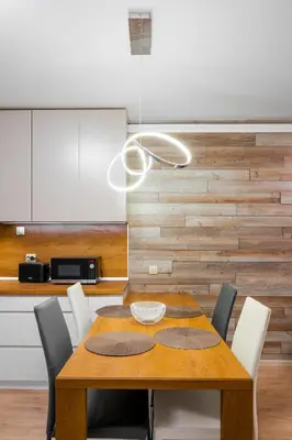 a dining room with a wooden table and chairs at Urban Elegance at Its Finest Stylish 1-BD Flat by Flat Mаnager in Sofia