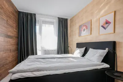 a bedroom with a large bed in front of a window at Urban Elegance at Its Finest Stylish 1-BD Flat by Flat Mаnager in Sofia