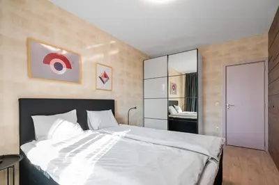 a bedroom with a large white bed and a mirror at Urban Elegance at Its Finest Stylish 1-BD Flat by Flat Mаnager in Sofia