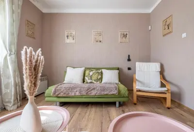 a small bedroom with a bed and a chair at #Maison\u32b6 - A Vibrant, Urban Stay in Sofia