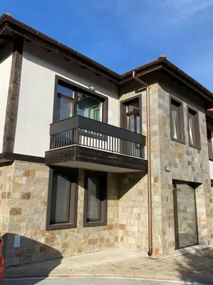 a building with a balcony on the side of it at Vacation house in Pravets golf resort At Pravets Lake in Pravets