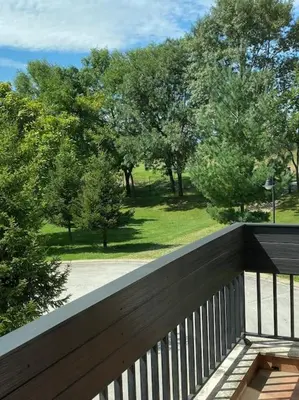 a wooden balcony with a view of a park at Vacation house in Pravets golf resort At Pravets Lake in Pravets