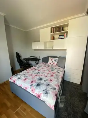 a bedroom with a bed and a table in it at Vacation house in Pravets golf resort At Pravets Lake in Pravets