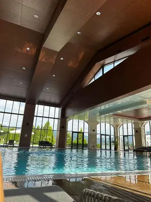 a large swimming pool in a building with windows at Vacation house in Pravets golf resort At Pravets Lake in Pravets