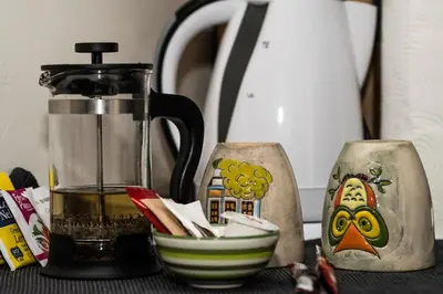 a kitchen counter with a coffee maker and a bowl at Апартамент до парк и метро in Sofia