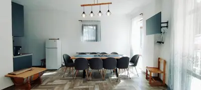 a kitchen and dining room with a table and chairs at Mountain Pearls Home 8 in Vodata