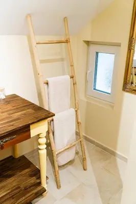 a ladder chair sitting next to a table in a room at Къща за гости РАДЕЯ in Govedartsi