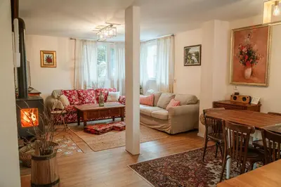 a living room with a couch and a table at Къща за гости РАДЕЯ in Govedartsi