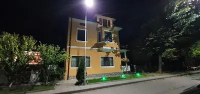 a yellow building with a light on top of it at АПАРТАМЕНТ ЮЛИЯ ДЕЛУКС I in Velingrad