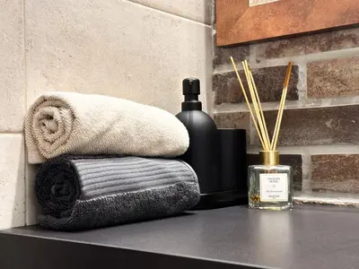 a towel and a bottle of soap on a counter at 2BR by NDK - AC - Desk - Lux Interior - Balcony in Sofia
