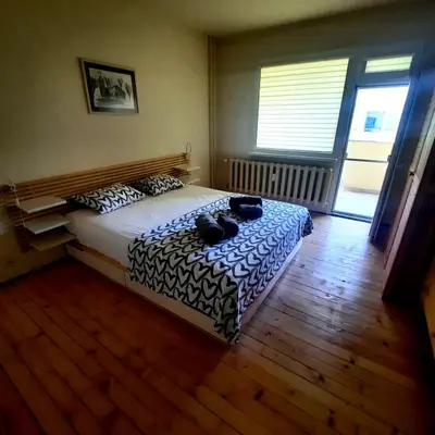 a bedroom with a bed with two bags on it at Spacious 3 bedroom apartment, close to metro station in Sofia