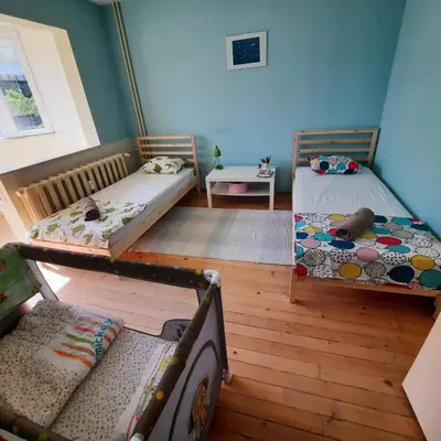a room with two bunk beds and a table at Spacious 3 bedroom apartment, close to metro station in Sofia