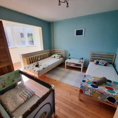 a room with two beds and a couch in it at Spacious 3 bedroom apartment, close to metro station in Sofia