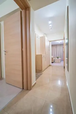 an empty hallway with a door and a room at Апартамент Амбра in Sandanski