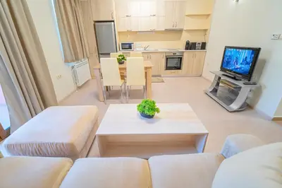 a living room with a couch and a table at Апартамент Амбра in Sandanski