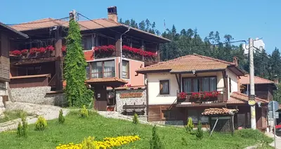 a house with flower boxes on the balconies of it at Denis Guest house in Koprivshtitsa