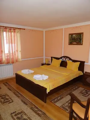 a bedroom with a bed with two towels on it at Denis Guest house in Koprivshtitsa