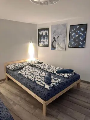 a large bed in a room with pictures on the wall at The rainbow 8 in Sofia