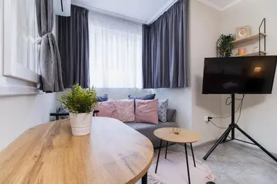 a living room with a table and a couch at City Center Studio Apartments in Plovdiv