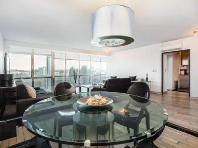 a living room with a glass table and chairs at Center Square Vitosha Blvd Panorama in Sofia