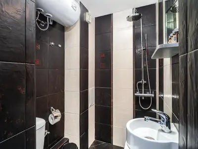 a bathroom with a sink and a shower at Center Square Vitosha Blvd Panorama in Sofia