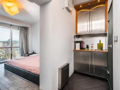 a bedroom with a bed and a large window at Center Square Vitosha Blvd Panorama in Sofia