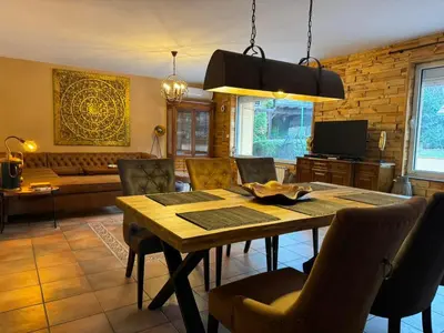 a dining room with a table and chairs and a couch at Villa Boyana City & Relax with Hot Jacuzzi and Sauna by BookVillaBG in Sofia