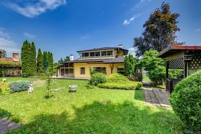 a large yellow house with a yard at Villa Boyana City & Relax with Hot Jacuzzi and Sauna by BookVillaBG in Sofia