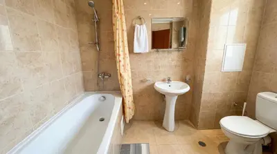 a bathroom with a tub and a toilet and a sink at South Facing Bright Mountain View Penthouse - 2 balconies, 300mbps WIFI, washer in Bansko