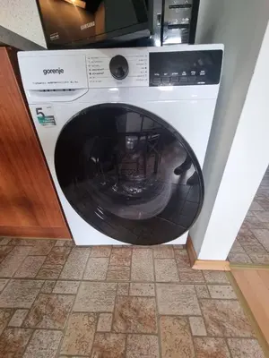 a washing machine is sitting in a kitchen at 1BR Homey Duplex 300mbps WIFI - Two Floor with washer in Bansko