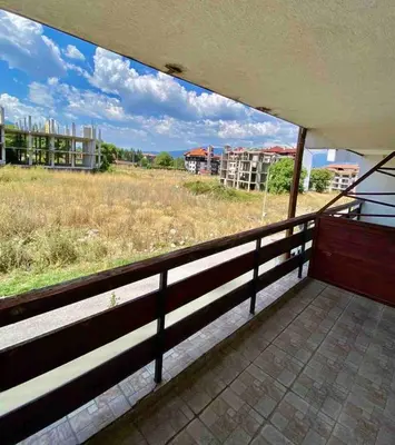 an empty balcony with a view of a field at 1BR Homey Duplex 300mbps WIFI - Two Floor with washer in Bansko