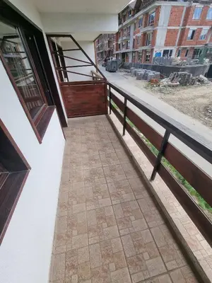 a balcony of a building with a wooden door at 1BR Homey Duplex 300mbps WIFI - Two Floor with washer in Bansko