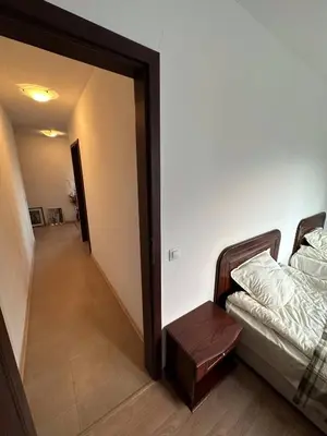 a living room with a couch and a hallway at 2BR Mountain View Apartment - Washer, 300mbps WIFI, Aircon in Bansko