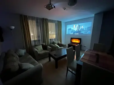 a living room with a couch and a tv at 2BR Mountain View Apartment - Washer, 300mbps WIFI, Aircon in Bansko