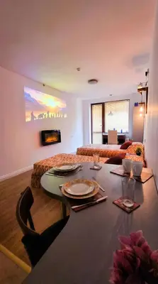 a living room with a table in a room at Mountain Paradise 2 - Quiet Cosy Studio - Balcony, Wifi in Bansko