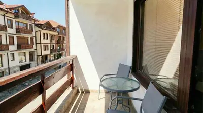 a balcony with a chair and a table and a window at Mountain Paradise 2 - Quiet Cosy Studio - Balcony, Wifi in Bansko