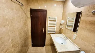a bathroom with a sink and a wooden door at Mountain Paradise 2 - Quiet Cosy Studio - Balcony, Wifi in Bansko