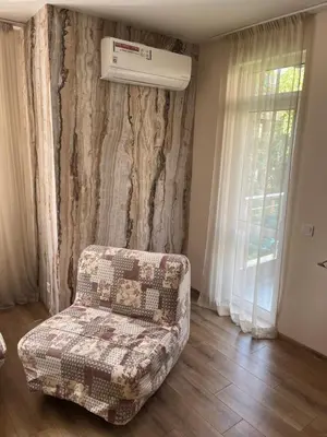 a living room with a couch and a air conditioner at APARTHOTEL VICTORY SOFIA in Sofia