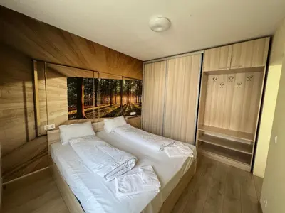 a bedroom with a large bed with white sheets at APARTHOTEL VICTORY SOFIA in Sofia
