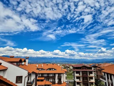 a view of buildings and a blue sky with clouds at Mountain Paradise 1 - 1 Bedroom South facing balcony - 300mbps Wi-fi in Bansko