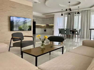 a living room with a couch and a table with chairs at Point Sofia Grand Suite in Sofia