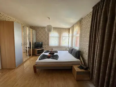 a bedroom with a bed and a television in it at Славина къща in Perushtitsa